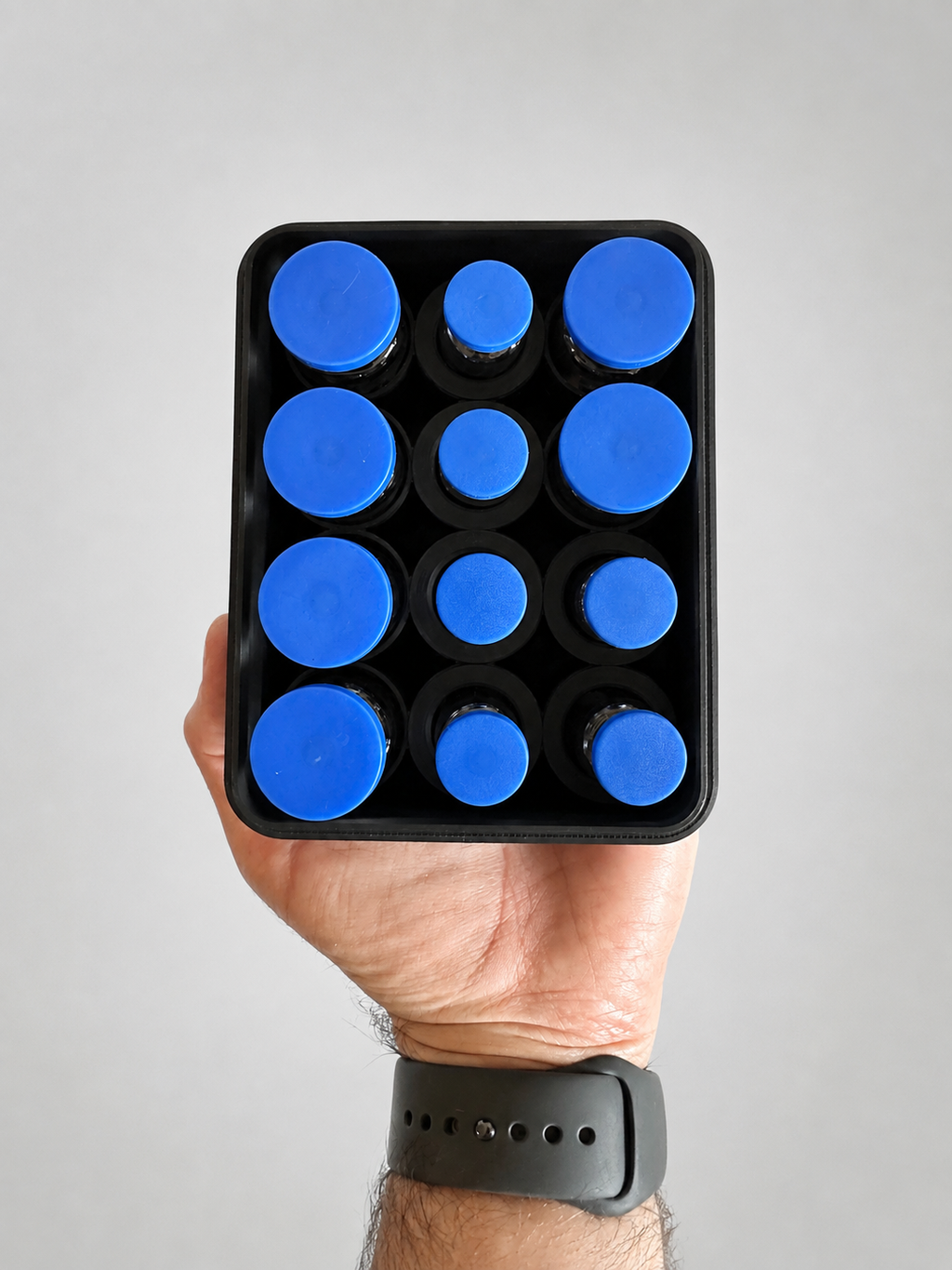 12-vial storage case shown from above in hand