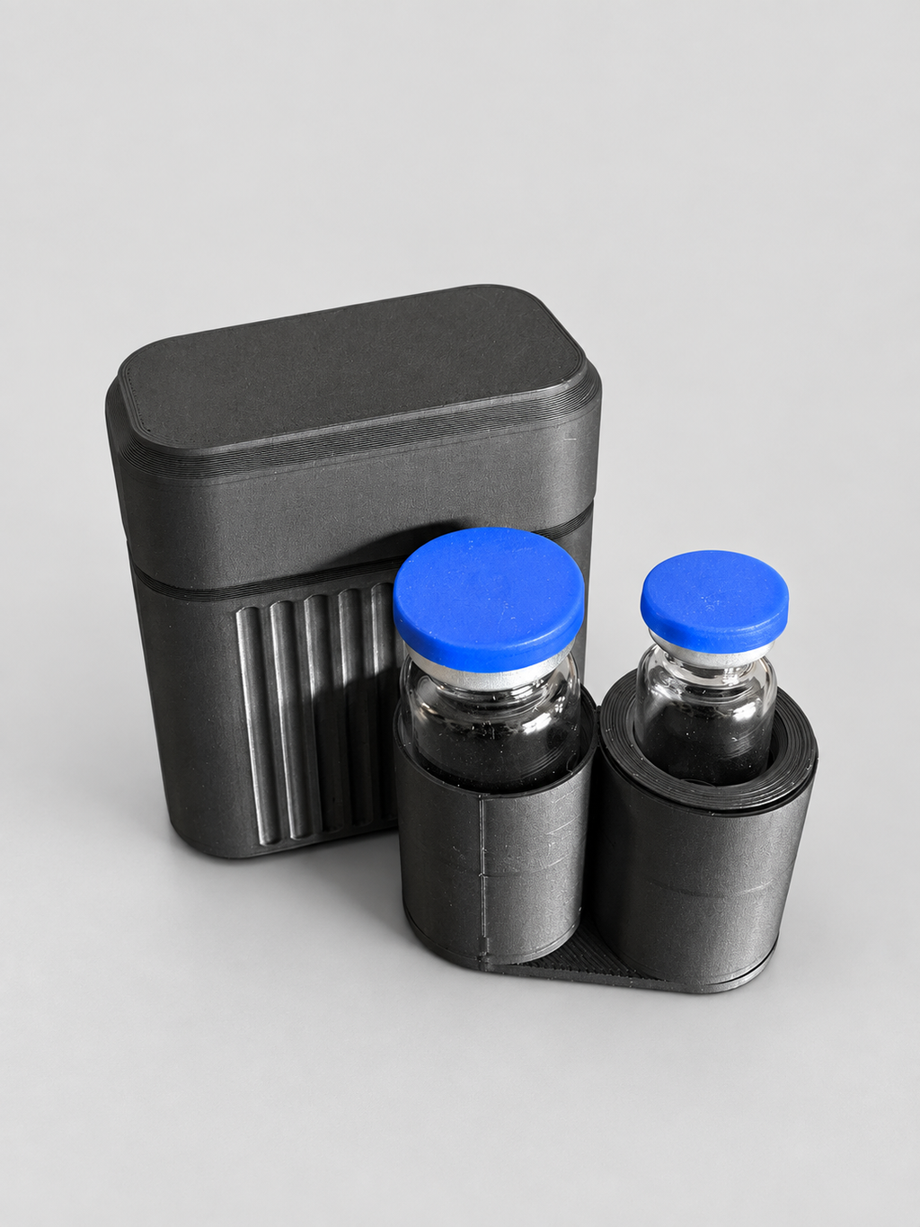2-vial case beside removable loaded tray