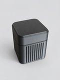 Closed black 4-vial storage case
