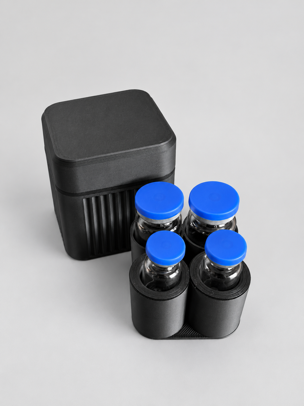 4-vial case beside removable loaded tray